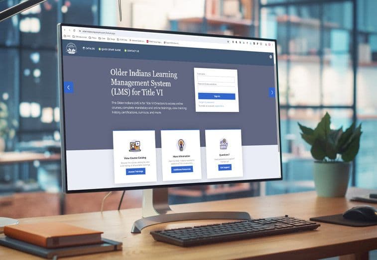A desktop computer with the Older Indians Learning Management System on it's monitor