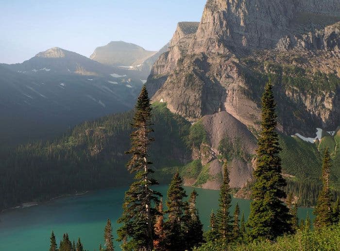 A dramatic landscape of mountains and a valley lake